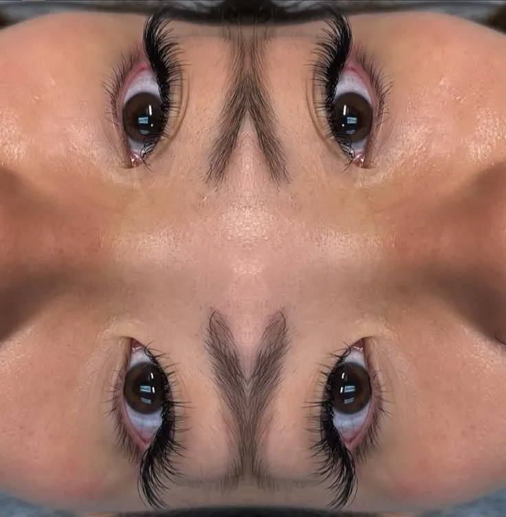 Symmetrical portfolio shot of mega-volume lash extensions with studio lighting reflections